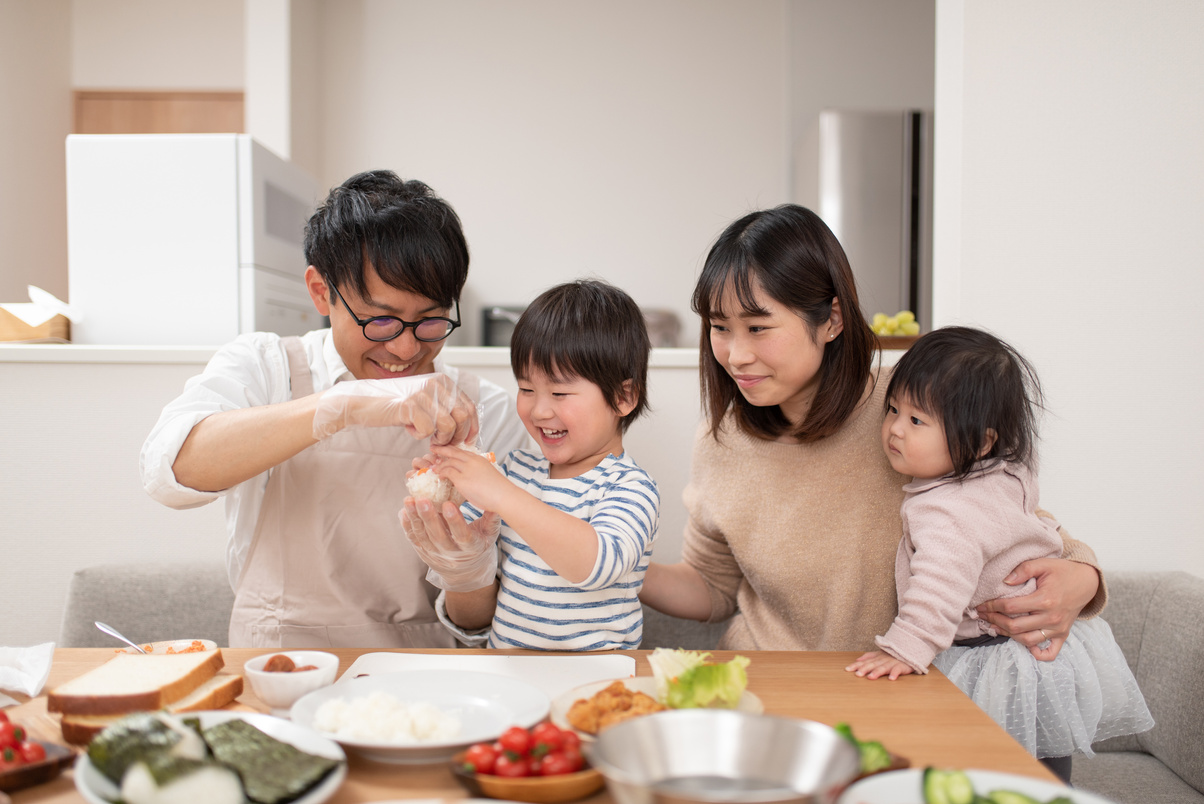 Toddler cooking rice ball with family